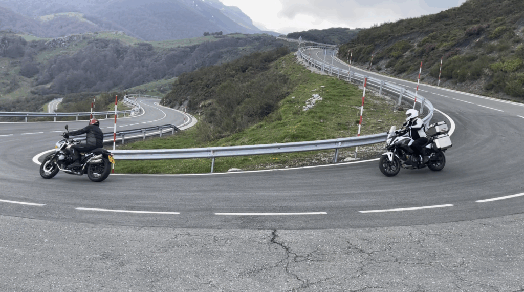 Two motorbikes, on a bend, on an Alpine pass