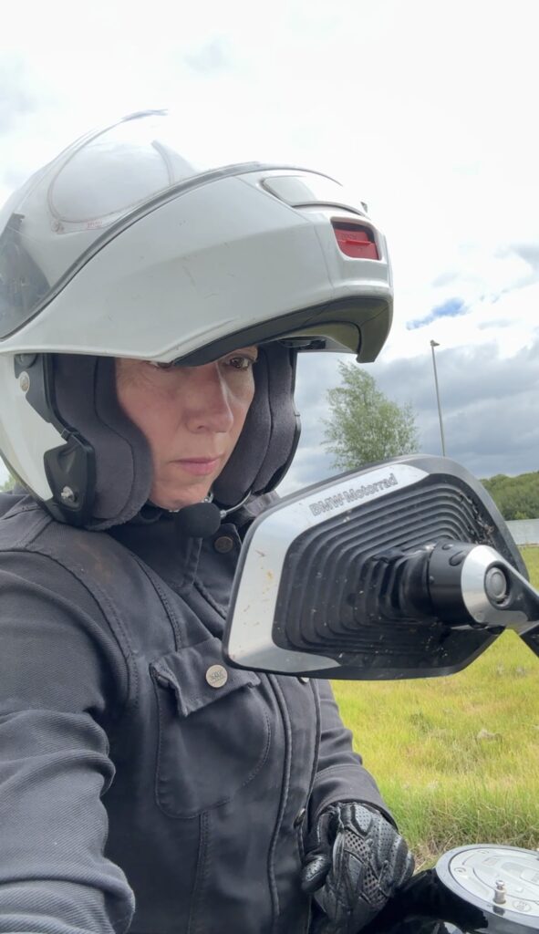 Checking mirrors on a motorbike to demonstrate looking into yourself and the past.