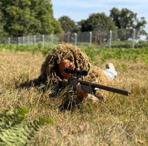 Camouflaged sniper