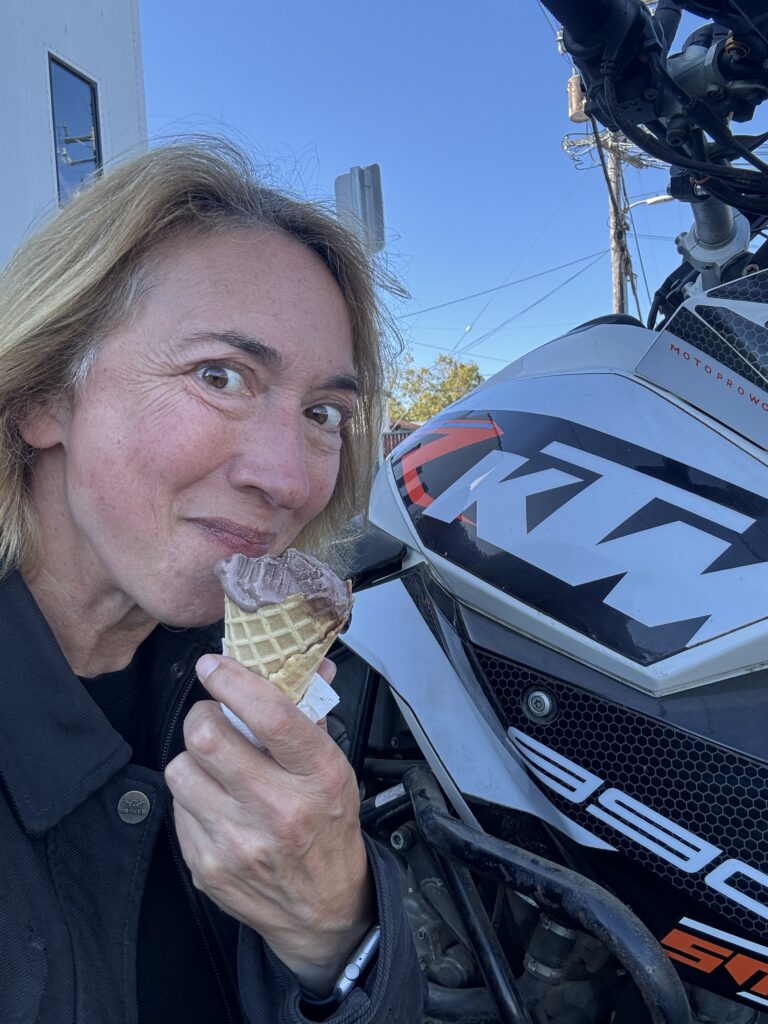Woman by a bike eating ice cream