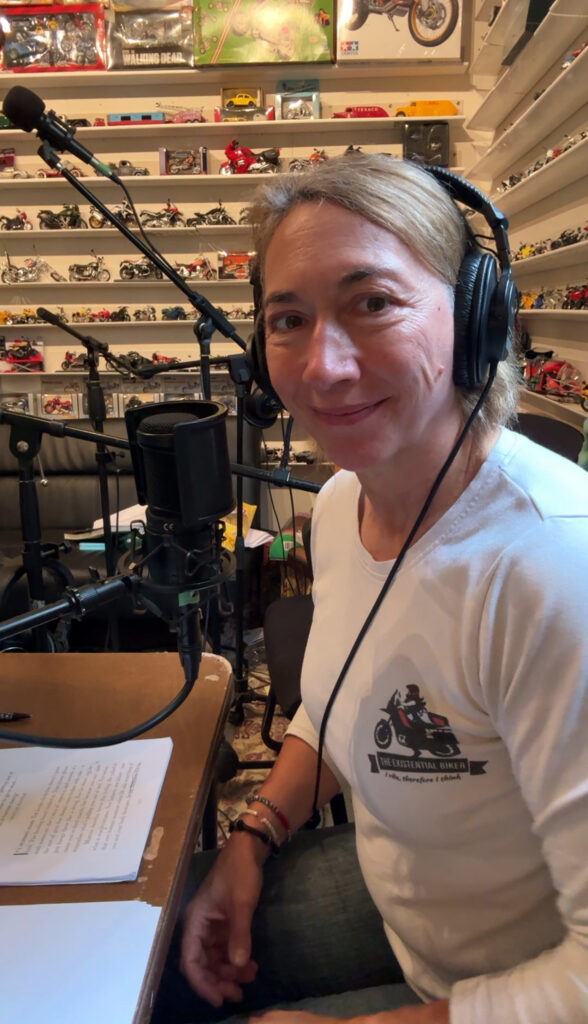 Existential Biker at a microphone